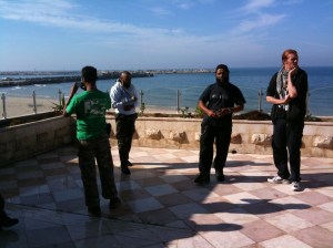 Convoy members taking photos overlooking the sea.