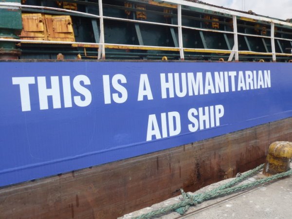Signs on the side of the large passenger ship read 'This is a humanitarian ship', in English, Arabic and Hebrew